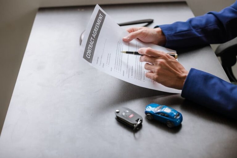A lawyer signing contract with client for statue of limitations in a car accident in Madison, WI