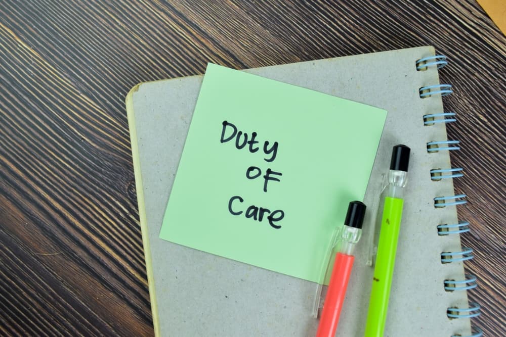 Visual representation of the Duty of Care concept, showcased through sticky notes on a wooden table.