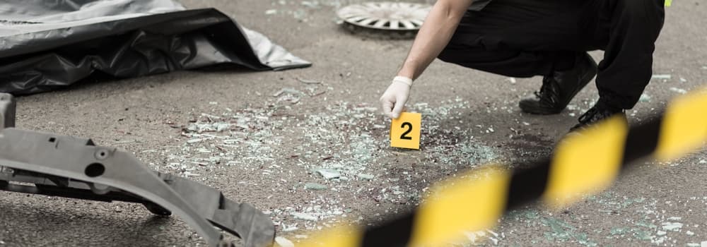 Shattered glass serves as evidence of a car collision.