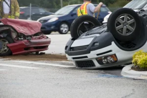 Emergency personnel rush to assist at a busy intersection following a rollover vehicle accident. 