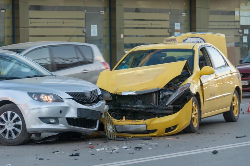 There has been a collision between two vehicles in the city: one is a taxi and the other is a public transportation vehicle.