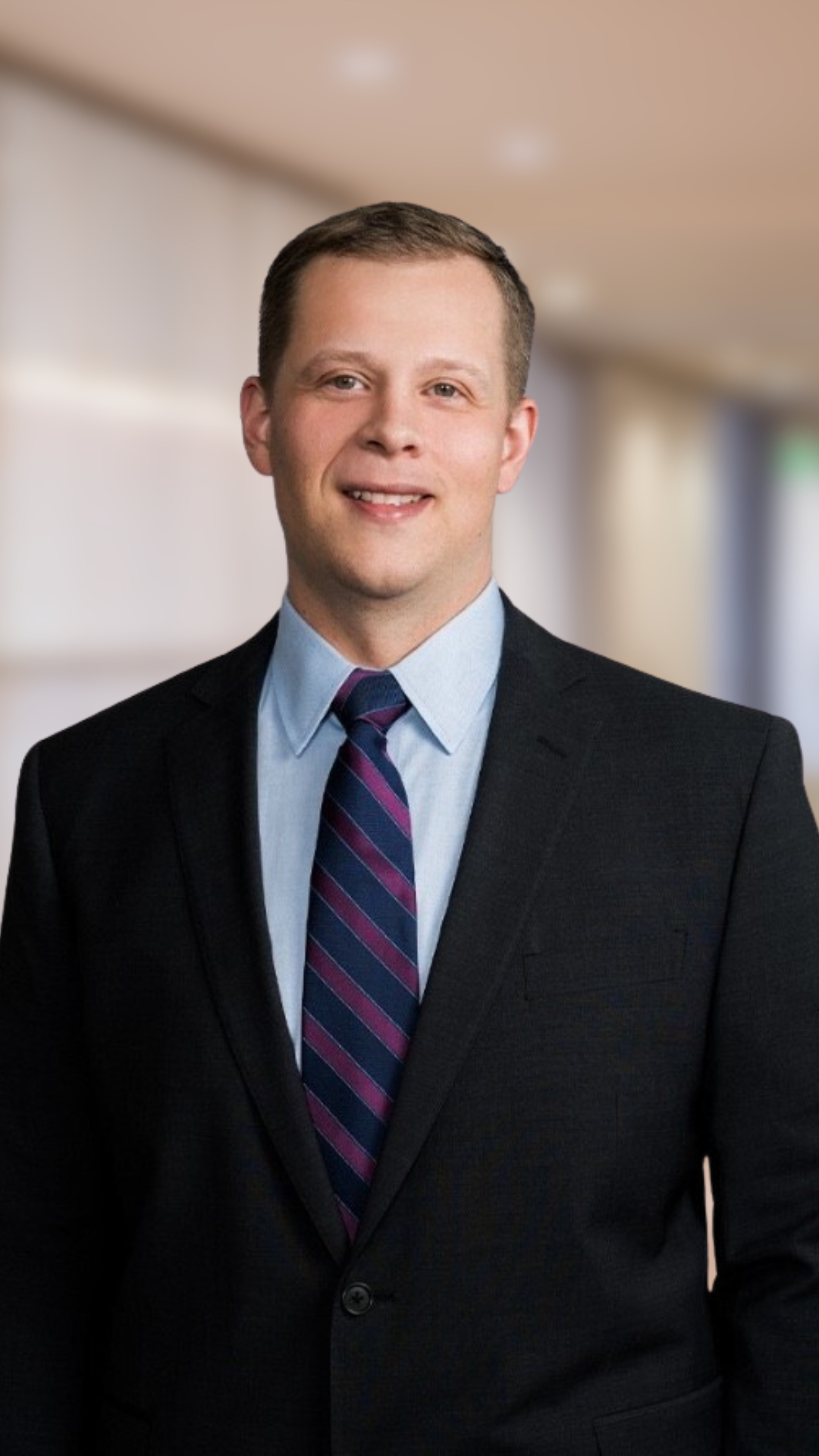 personal injury lawyer jonathan esp wears a dark suit and striped tie