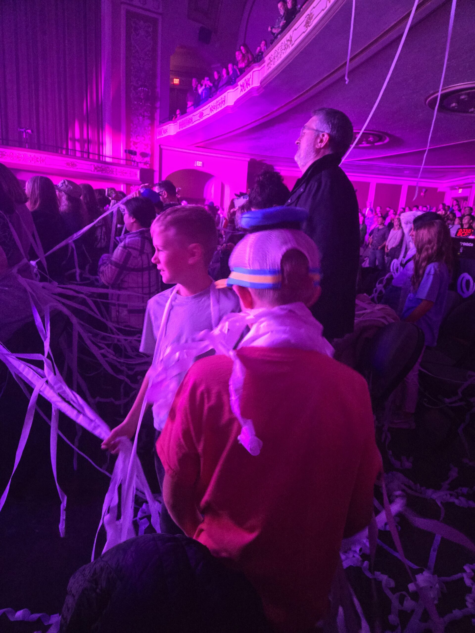 fans watch jeremy camp in concert under a purple glow and decorations