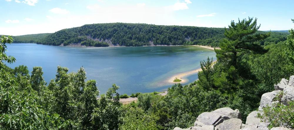 a photo of the rocky and green landscape at devil's lake in Baraboo, wisconsin