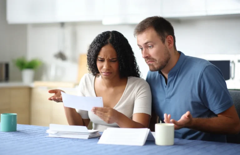 A woman and man appear to debate whether to accept a check, the amount is unknown