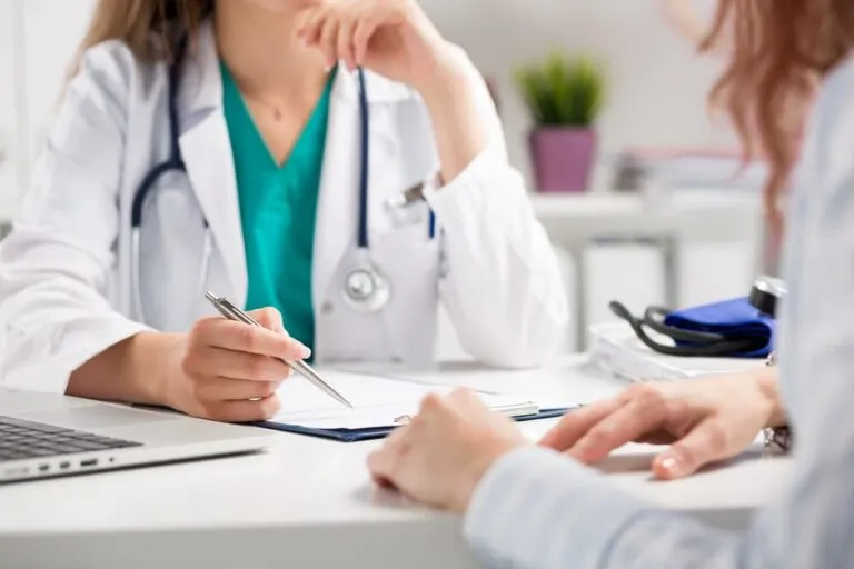 Closeup of doctor consulting patient in medical office. Women's healthcare and prevention.
