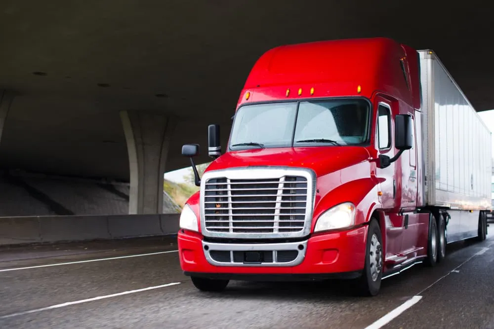 Semi Truck Under A Bridge On A Highway