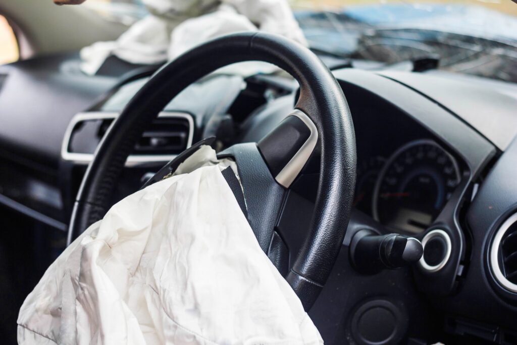 Deployed airbag in a car after a crash, illustrating the topic of defective airbag injuries