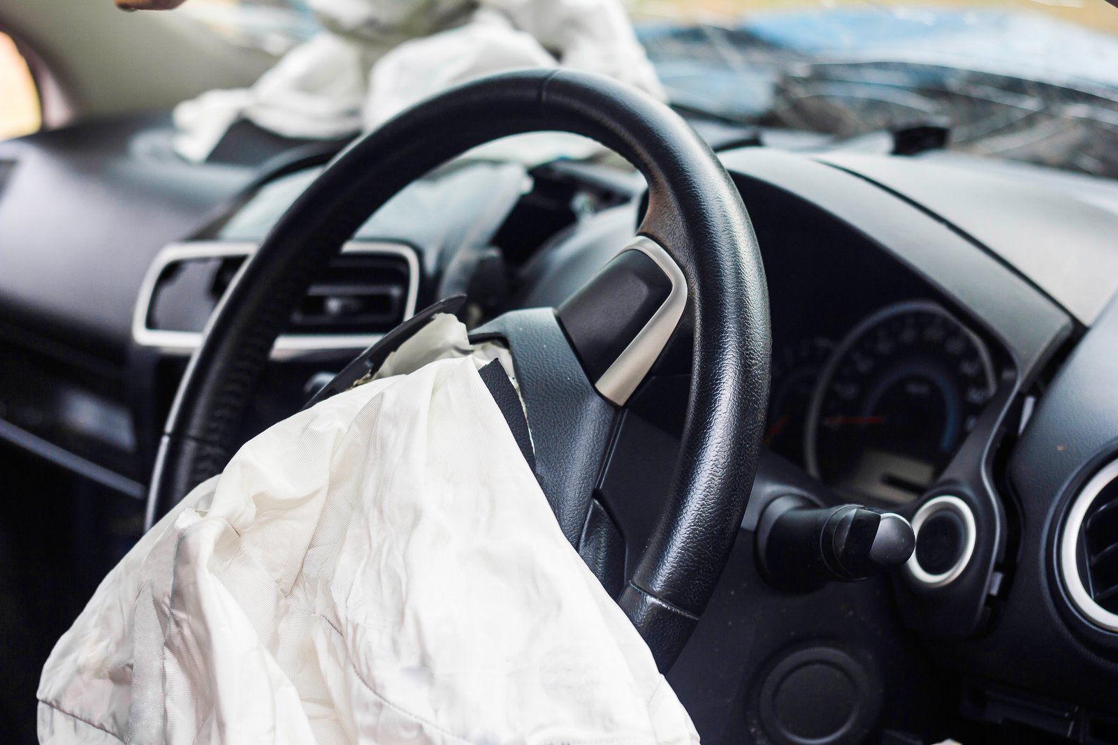 Deployed airbag in a car after a crash, illustrating the topic of defective airbag injuries